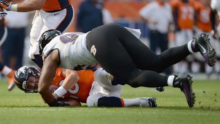 Sep 13, 2015; Denver, CO, USA; Baltimore Ravens defensive end Chris Canty (99) sacks Denver Broncos quarterback Peyton Manning (18) in the third quarter at Sports Authority Field at Mile High. The Broncos won 19-13. Mandatory Credit: Ron Chenoy-USA TODAY Sports