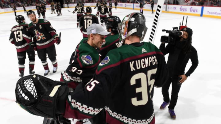 GLENDALE, ARIZONA - NOVEMBER 16: Goalie Darcy Kuemper #35 of the Arizona Coyotes is congratulated by teammate Antti Raanta #32 following his 3-0 shutout victory against the Calgary Flames at Gila River Arena on November 16, 2019 in Glendale, Arizona. Kuemper was playing in his 200th career NHL game. (Photo by Norm Hall/NHLI via Getty Images)
