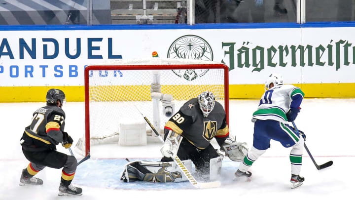 Robin Lehner #90 of the Vegas Golden Knights stops a shot against Elias Pettersson #40 of the Vancouver Canucks