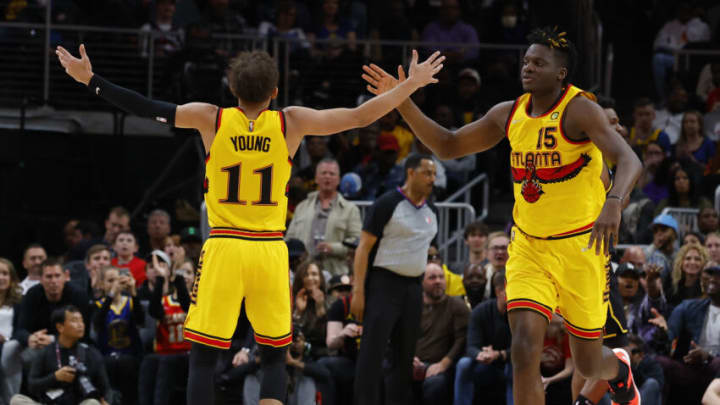 ATLANTA, GA - MARCH 25: Trae Young #11 reacts with Clint Capela #15 of the Atlanta Hawks during the first half against the Golden State Warriors at State Farm Arena on March 25, 2022 in Atlanta, Georgia. NOTE TO USER: User expressly acknowledges and agrees that, by downloading and or using this photograph, User is consenting to the terms and conditions of the Getty Images License Agreement. (Photo by Todd Kirkland/Getty Images)