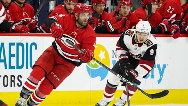 RALEIGH, NC - DECEMBER 16: Carolina Hurricanes Winger Jordan Martinook (48) passes a puck away from Arizona Coyotes Winger Clayton Keller (9) during a game between the Carolina Hurricanes and the Arizona Coyotes at the PNC Arena in Raleigh, NC on December 16, 2018. (Photo by Greg Thompson/Icon Sportswire via Getty Images)