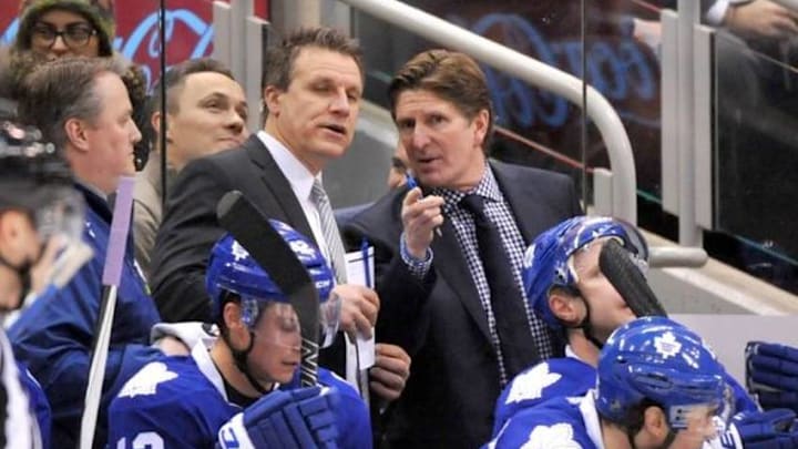 Jan 13, 2016; Toronto, Ontario, CAN; Toronto Maple Leafs head coach Mike Babcock (right) gestures as he speaks with assistant coach Jim Hiller during a time out against Columbus Blue Jackets at Air Canada Centre. Mandatory Credit: Dan Hamilton-USA TODAY Sports