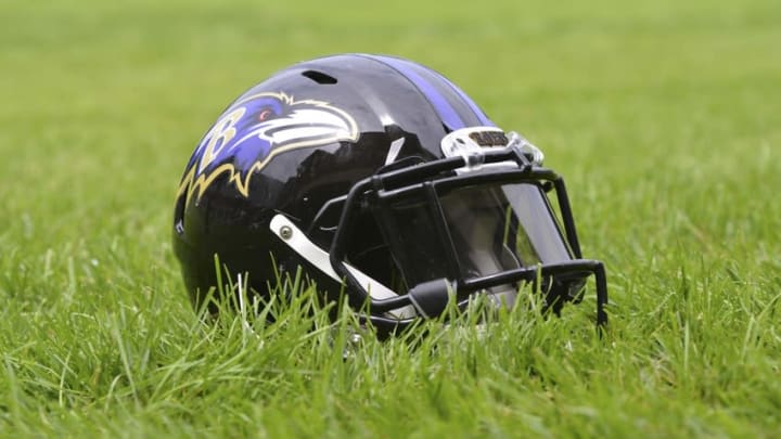 Jul 24, 2014; Owings Mills, MD, USA; A detailed view of an Baltimore Ravens helmet in the grass after practice at Under Armour Performance Center. Mandatory Credit: Tommy Gilligan-USA TODAY Sports