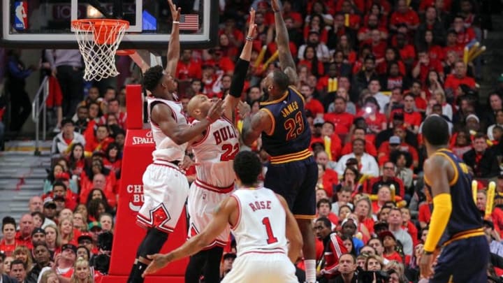 May 10, 2015; Chicago, IL, USA; Cleveland Cavaliers forward LeBron James (23) scores over Chicago Bulls forward Taj Gibson (22) and guard Jimmy Butler (21) in the second half of game four of the second round of the NBA Playoffs at the United Center. Cleveland won 86-84. Mandatory Credit: Dennis Wierzbicki-USA TODAY Sports