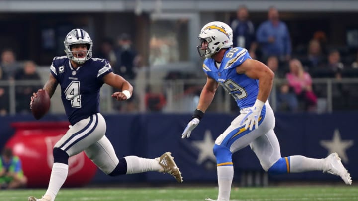 ARLINGTON, TX - NOVEMBER 23: Dak Prescott #4 of the Dallas Cowboys scrambles under pressure from Joey Bosa #99 of the Los Angeles Chargers in the first quarter of a football game at AT&T Stadium on November 23, 2017 in Arlington, Texas. (Photo by Tom Pennington/Getty Images)