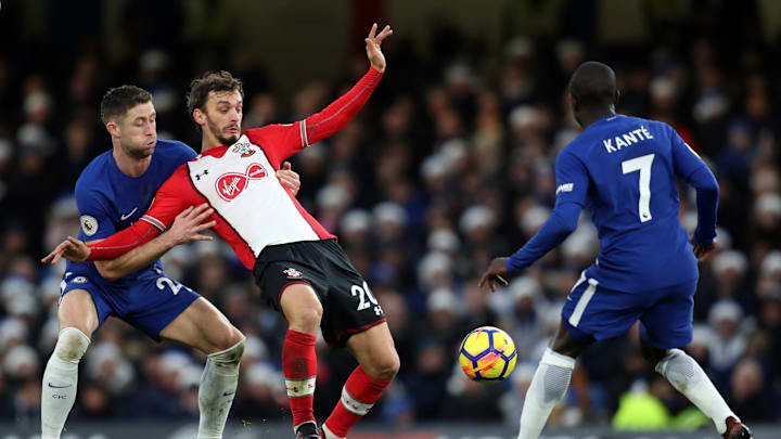 LONDON, ENGLAND – DECEMBER 16: Gary Cahill of Chelsea holds up Manolo Gabbiadini of Southampton as he competes for the ball with N’Golo Kante of Chelsea during the Premier League match between Chelsea and Southampton at Stamford Bridge on December 16, 2017 in London, England. (Photo by Catherine Ivill/Getty Images)