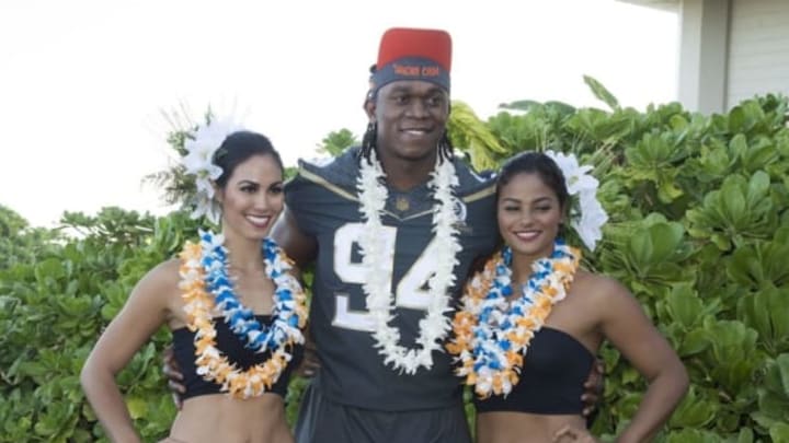 January 29, 2016; Kahuku, HI, USA; Hawaiian hostesses Chelsea Hardin (far left) and Mahina Garcia (far right) pose with Team Irvin defensive end Ezekiel Ansah of the Detroit Lions (94) during 2016 Pro Bowl photo day at Turtle Bay Resort. Mandatory Credit: Kyle Terada-USA TODAY Sports