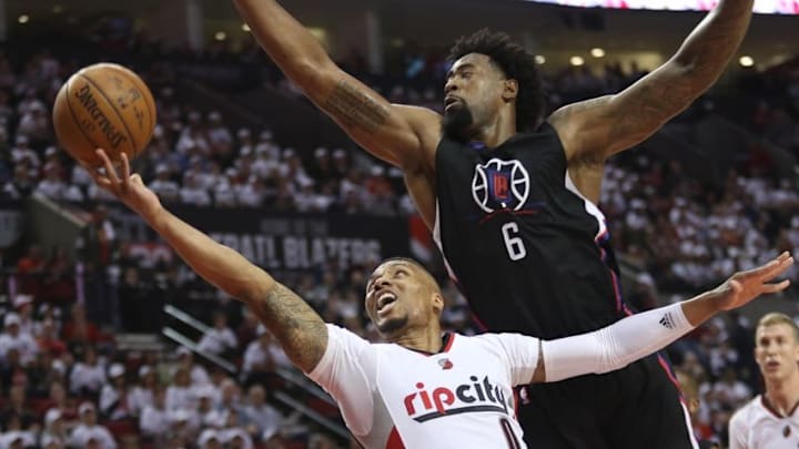 Apr 23, 2016; Portland, OR, USA; Portland Trail Blazers guard Damian Lillard (0) shoots against Los Angeles Clippers center DeAndre Jordan (6) in game three of the first round of the NBA Playoffs at Moda Center at the Rose Quarter. Mandatory Credit: Jaime Valdez-USA TODAY Sports