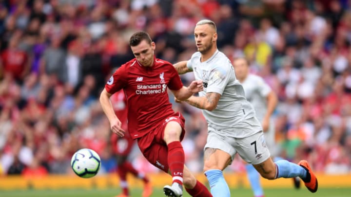 LIVERPOOL, ENGLAND - AUGUST 12: Andy Robertson of Liverpool and Marko Arnautovic of West Ham United battle for possession during the Premier League match between Liverpool FC and West Ham United at Anfield on August 12, 2018 in Liverpool, United Kingdom. (Photo by Laurence Griffiths/Getty Images)