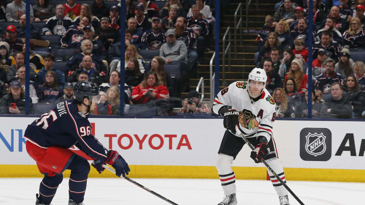 Dec 31, 2022; Columbus, Ohio, USA; Chicago Blackhawks right wing Patrick Kane (88) passes the puck as Columbus Blue Jackets center Jack Roslovic (96) defendsduring the first period at Nationwide Arena. Mandatory Credit: Russell LaBounty-USA TODAY Sports