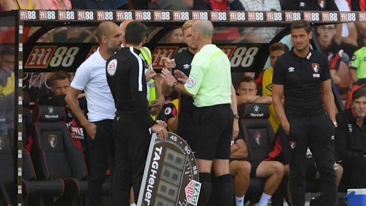 BOURNEMOUTH, ENGLAND - AUGUST 26: Referee Mike Dean talks to both Pep Guardiola and Eddie Howe during the Premier League match between AFC Bournemouth and Manchester City at Vitality Stadium on August 26, 2017 in Bournemouth, England. (Photo by Mike Hewitt/Getty Images)