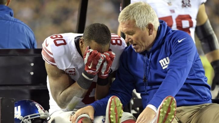 Oct 12, 2014; Philadelphia, PA, USA; New York Giants wide receiver Victor Cruz (80) with trainer Byron Hansen as he is carted off the field after an injury during the third quarter against the Philadelphia Eagles at Lincoln Financial Field. Mandatory Credit: Eric Hartline-USA TODAY Sports