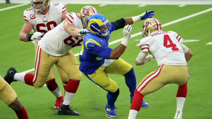 INGLEWOOD, CALIFORNIA – NOVEMBER 29: Aaron Donald #99 of the Los Angeles Rams attempts to sack Nick Mullens #4 of the San Francisco 49ers during the first half at SoFi Stadium on November 29, 2020 in Inglewood, California. (Photo by Katelyn Mulcahy/Getty Images)