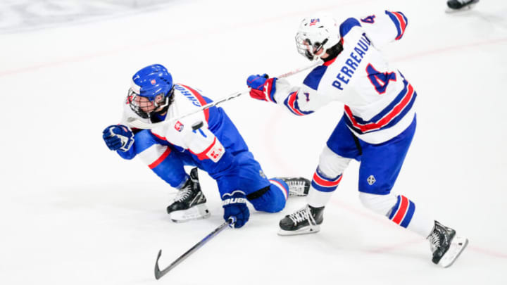 BASEL, SWITZERLAND - APRIL 29: Gabe Perreault of United States (R) shots is blocked by Jakub Chromiak of Slovakia during the semi final of U18 Ice Hockey World Championship match between United States and Slovakia at St. Jakob-Park on April 29, 2023 in Basel, Switzerland. (Photo by Jari Pestelacci/Eurasia Sport Images/Getty Images)