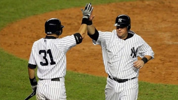 August 17, 2012; Bronx, NY, USA; New York Yankees third baseman Casey McGehee (45) is high fived by on-deck batter Ichiro Suzuki (31) after scoring on an RBI single by Jayson Nix (not pictured) during the sixth inning of a game against the Boston Red Sox at Yankee Stadium. Mandatory Credit: Brad Penner-USA TODAY Sports