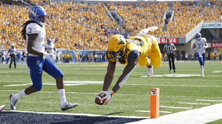MORGANTOWN, WV - OCTOBER 06: Jovani Haskins #84 of the West Virginia Mountaineers dives into the end zone for a 14-yard touchdown after catching a pass against the Kansas Jayhawks in the second quarter of the game at Mountaineer Field on October 6, 2018 in Morgantown, West Virginia. (Photo by Joe Robbins/Getty Images)