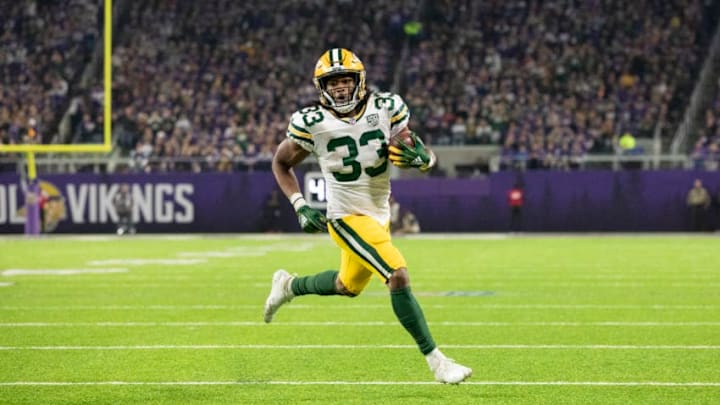 MINNEAPOLIS, MN - NOVEMBER 25: Aaron Jones #33 of the Green Bay Packers runs with the ball for a six-yard touchdown in the second quarter of the game against the Minnesota Vikings at U.S. Bank Stadium on November 25, 2018 in Minneapolis, Minnesota. (Photo by Adam Bettcher/Getty Images)