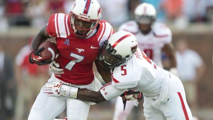 Der’rikk Thompson #7 of the SMU Mustangs is tackled by Tre’ Porter #5 of the Texas Tech Red Raiders (Photo by Cooper Neill/Getty Images)