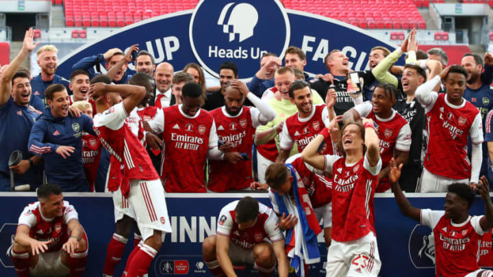 LONDON, ENGLAND - AUGUST 01: Players react as Pierre-Emerick Aubameyang of Arsenal drops the Fa Cup Trophy during the FA Cup Final match between Arsenal and Chelsea at Wembley Stadium on August 1, 2020 in London, England. Football Stadiums around Europe remain empty due to the Coronavirus Pandemic as Government social distancing laws prohibit fans inside venues resulting in all fixtures being played behind closed doors. (Photo by Marc Atkins/Getty Images)