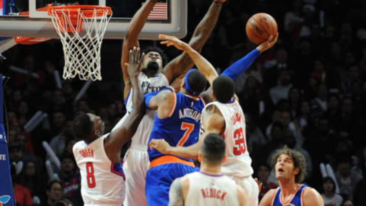 March 11, 2016; Los Angeles, CA, USA; New York Knicks forward Carmelo Anthony (7) moves to the basket against Los Angeles Clippers center DeAndre Jordan (6), forward Wesley Johnson (33) and forward Jeff Green (8) during the second half at Staples Center. Mandatory Credit: Gary A. Vasquez-USA TODAY Sports
