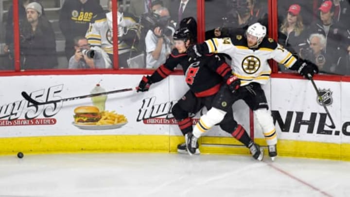 RALEIGH, NORTH CAROLINA – MAY 14: Brock McGinn #23 of the Carolina Hurricanes collides with Chris Wagner #14 of the Boston Bruins during the second period in Game Three of the Eastern Conference Finals during the 2019 NHL Stanley Cup Playoffs at PNC Arena on May 14, 2019 in Raleigh, North Carolina. (Photo by Grant Halverson/Getty Images)