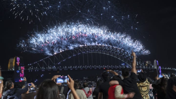 SYDNEY, AUSTRALIA - JANUARY 01: Fireworks light up the sky over Sydney Harbour as the clock strikes midnight on January 01, 2022 in Sydney, Australia. New Year's Eve celebrations continue to be somewhat different as some COVID-19 restrictions remain in place due to the ongoing coronavirus pandemic. There were 21,151 news cases of COVID-19 recorded in New South Wales on the final day of 2021, setting a new record for the Australia’s most populous state (Photo by Brook Mitchell/Getty Images)