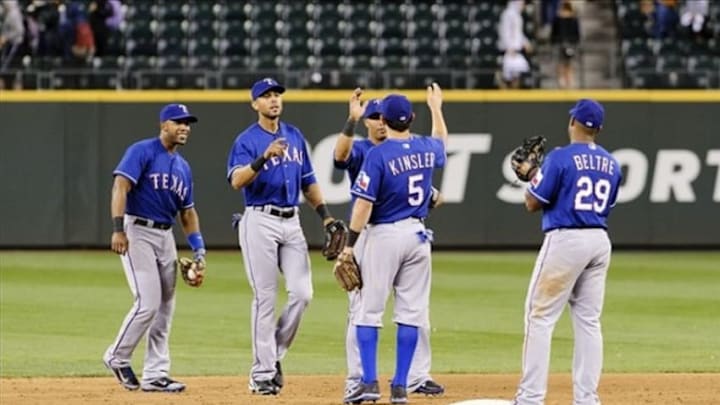 Aug 27, 2013; Seattle, WA, USA; The Texas Rangers celebrate after defeating the Seattle Mariners in the 10th inning at Safeco Field. Texas defeated Seattle 4-3. Mandatory Credit: Steven Bisig-USA TODAY Sports