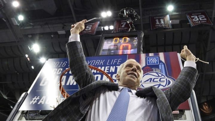 Mar 12, 2016; Washington, DC, USA; North Carolina Tar Heels head coach Roy Williams raises his arm after cutting down the net after the championship game of the ACC conference tournament at Verizon Center. North Carolina Tar Heels defeated Virginia Cavaliers 61-57. Mandatory Credit: Tommy Gilligan-USA TODAY Sports