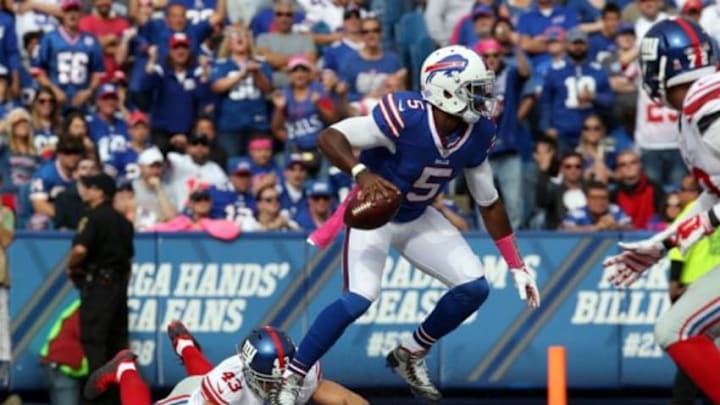 Oct 4, 2015; Orchard Park, NY, USA; Buffalo Bills quarterback Tyrod Taylor (5) scrambles with the ball while avoiding a tackle by New York Giants defensive back Craig Dahl (43) during the second half at Ralph Wilson Stadium. Giants beat the Bills 24 to 10. Mandatory Credit: Timothy T. Ludwig-USA TODAY Sports