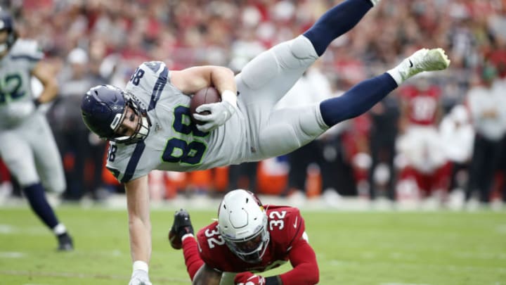GLENDALE, ARIZONA - SEPTEMBER 29: Tight end Will Dissly #88 of the Seattle Seahawks is up-ended by safety Budda Baker #32 of the Arizona Cardinals after a catch during the first half of the NFL football game at State Farm Stadium on September 29, 2019 in Glendale, Arizona. (Photo by Ralph Freso/Getty Images)