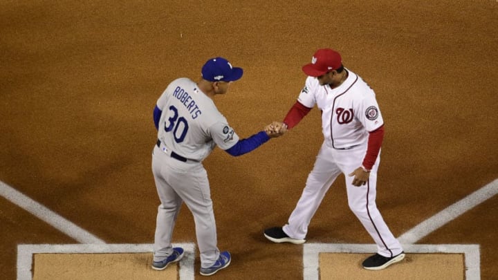 WASHINGTON, DC - OCTOBER 06: Manager Dave Roberts #30 of the Los Angeles Dodgers and manager Dave Martinez #4 of the Washington Nationals shake hands before the start of Game 3 of the NLDS at Nationals Park on October 6, 2019 in Washington, DC. (Photo by Patrick McDermott/Getty Images)