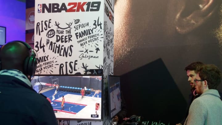 PARIS, FRANCE - OCTOBER 25: Gamers play the video game 'NBA 2K19' developed by Visual Concepts and published by 2K Sports during the 'Paris Games Week' on October 25, 2018 in Paris, France. 'Paris Games Week' is an international trade fair for video games and runs from October 26 to 31, 2018. (Photo by Chesnot/Getty Images)