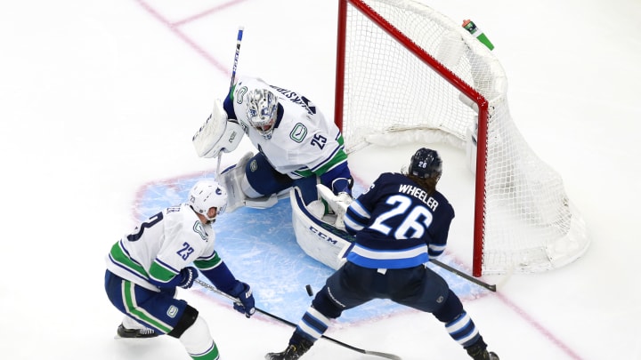 Canucks versus Jets. (Photo by Jeff Vinnick/Getty Images)