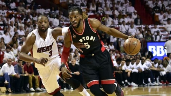 May 7, 2016; Miami, FL, USA; Toronto Raptors forward DeMarre Carroll (5) dribbles the ball past Miami Heat guard Dwyane Wade (3) during the first quarter in game three of the second round of the NBA Playoffs at American Airlines Arena. Mandatory Credit: Steve Mitchell-USA TODAY Sports