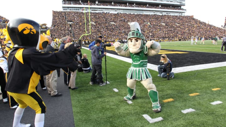 IOWA CITY, IA - NOVEMBER 12: Herky the mascot of the Iowa Hawkeyes battles with Sparty of the Michigan State Spartans before kickoff at Kinnick Stadium November 12, 2011 in Iowa City, Iowa. Michigan State beat Iowa 37-21. (Photo by Reese Strickland/Getty Images)