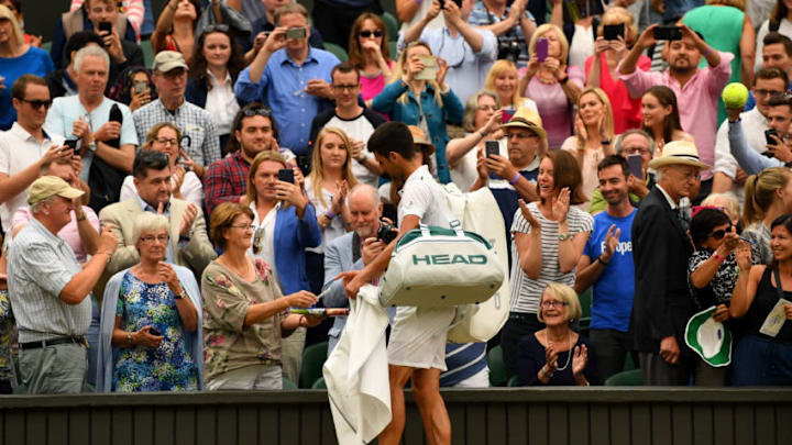 LONDON, ENGLAND - JULY 11: Novak Djokovic of Serbia signs autographs after victory in the Gentlemen's Singles fourth round match against Adrian Mannarino of France on day eight of the Wimbledon Lawn Tennis Championships at the All England Lawn Tennis and Croquet Club on July 11, 2017 in London, England. (Photo by Shaun Botterill/Getty Images)