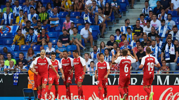 BARCELONA, SPAIN - AUGUST 18: Sevilla FC players celebrate with their teammate Sergio Reguilon after scoring the opening goal during the Liga match between RCD Espanyol and Sevilla FC at RCDE Stadium on August 18, 2019 in Barcelona, Spain. (Photo by Alex Caparros/Getty Images)