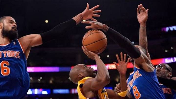 Mar 25, 2014; Los Angeles, CA, USA; Los Angeles Lakers guard Jodie Meeks (20) gets his shot blocked by New York Knicks guard J.R. Smith (8) during second half action at Staples Center. Left is New York Knicks center Tyson Chandler (6) and right is New York Knicks forward Amar