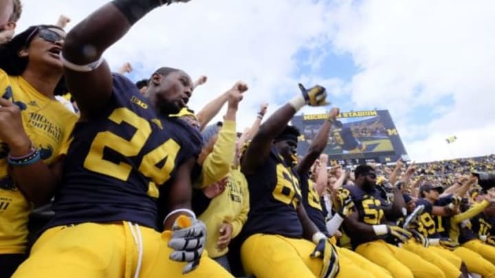 Sep 19, 2015; Ann Arbor, MI, USA; Michigan Wolverines players celebrate in the student section after the game against the UNLV Rebels at Michigan Stadium. Michigan won 28-7. Mandatory Credit: Rick Osentoski-USA TODAY Sports