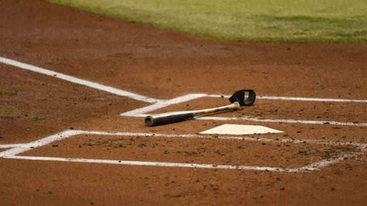 PHOENIX, ARIZONA - SEPTEMBER 13: A detail of a bat and elbow guard laying next to home plate during a game between the Arizona Diamondbacks and the Seattle Mariners at Chase Field on September 13, 2020 in Phoenix, Arizona. (Photo by Norm Hall/Getty Images)