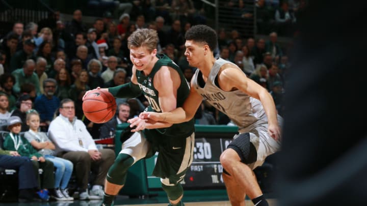 EAST LANSING, MI - DECEMBER 21: Matt McQuaid #20 of the Michigan State Spartans drives to the basket while defended by Jaevin Cumberland #21 of the Oakland Golden Grizzlies in the first half at Breslin Center on December 21, 2018 in East Lansing, Michigan. (Photo by Rey Del Rio/Getty Images)