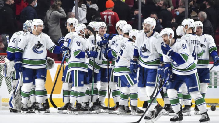 MONTREAL, QC - NOVEMBER 29: The Vancouver Canucks celebrate their victory against the Montreal Canadiens at Centre Bell on November 29, 2021 in Montreal, Canada. The Vancouver Canucks defeated the Montreal Canadiens 2-1. (Photo by Minas Panagiotakis/Getty Images)