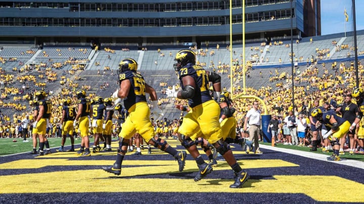 Michigan players, including offensive lineman LaDarius Henderson (73) warm up before the East Carolina game at Michigan Stadium in Ann Arbor on Saturday, Sept. 2, 2023.