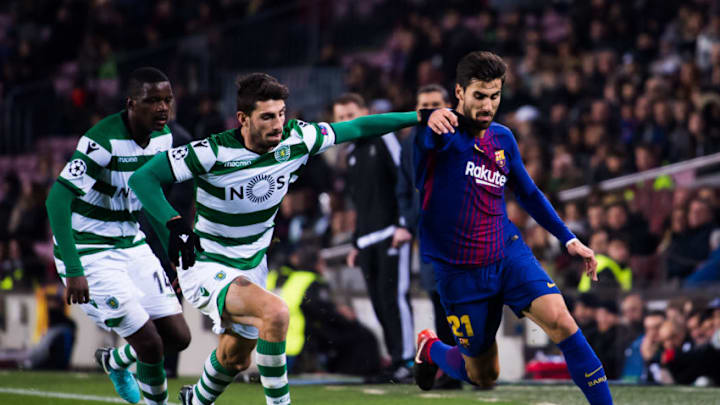 BARCELONA, SPAIN - DECEMBER 05: Andre Gomes of FC Barcelona conducts the ball under pressure from Cristiano Piccini and William Carvalho of Sporting CP during the UEFA Champions League group D match between FC Barcelona and Sporting CP at Camp Nou on December 5, 2017 in Barcelona, Spain. (Photo by Alex Caparros/Getty Images)