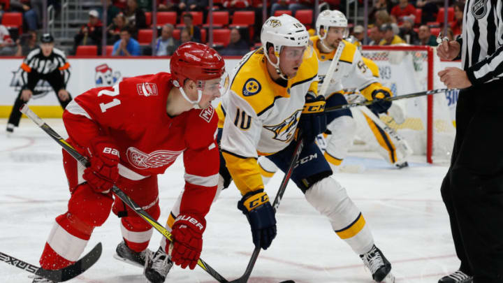 DETROIT, MI - FEBRUARY 20: Detroit Red Wings forward Dylan Larkin (71) and Nashville Predators forward Colton Sissons (10) keeps their eyes on the puck after a face-off during a regular season NHL hockey game between the Nashville Predators and the Detroit Red Wings on February 20, 2018, at Little Caesars Arena in Detroit, Michigan. (Photo by Scott W. Grau/Icon Sportswire via Getty Images)