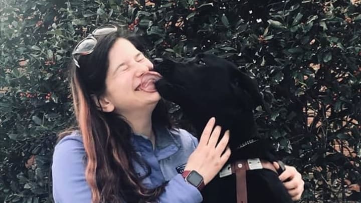 Seeing Eye instructor Sarah Indano with a black Lab she trained.