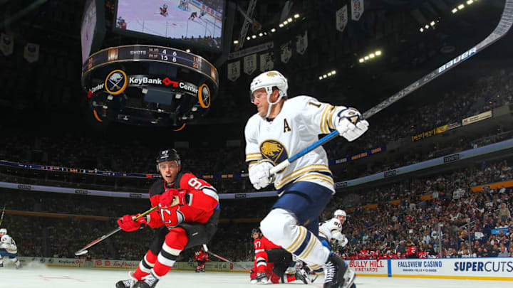 BUFFALO, NY - OCTOBER 5: Jake McCabe #19 of the Buffalo Sabres skates against Nikita Gusev #97 of the New Jersey Devils during an NHL game on October 5, 2019 at KeyBank Center in Buffalo, New York. Buffalo won, 7-2. (Photo by Bill Wippert/NHLI via Getty Images)