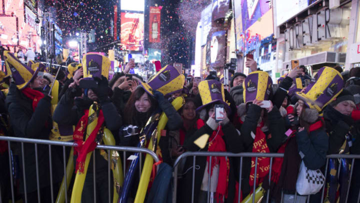 Revelers celebrate as the ball drops to welcome in the new year during New Year's Eve celebrations in Times Square on January 1, 2018 in New York. / AFP PHOTO / DON EMMERT (Photo credit should read DON EMMERT/AFP/Getty Images)