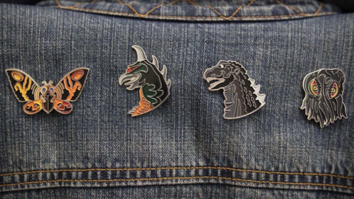 These enamel pins from Mondo celebrate the 65-year history of Godzilla.