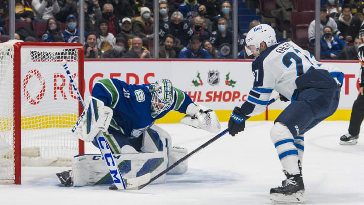 Dec 10, 2021; Vancouver, British Columbia, CAN; Vancouver Canucks goalie Thatcher Demko (35) makes a save on Winnipeg Jets forward Nikolaj Ehlers (27) in the overtime period at Rogers Arena. Vancouver wins 4-3 in a shootout. Mandatory Credit: Bob Frid-USA TODAY Sports